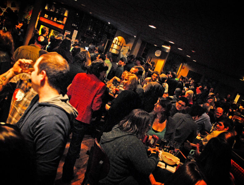 crowd gathered at a bar