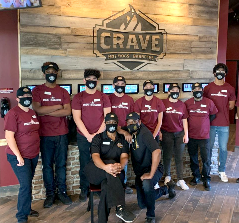 Restaurant crew posing with masks