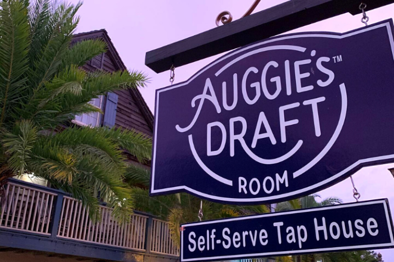 A close-up of the sign for Auggie's Draft Room