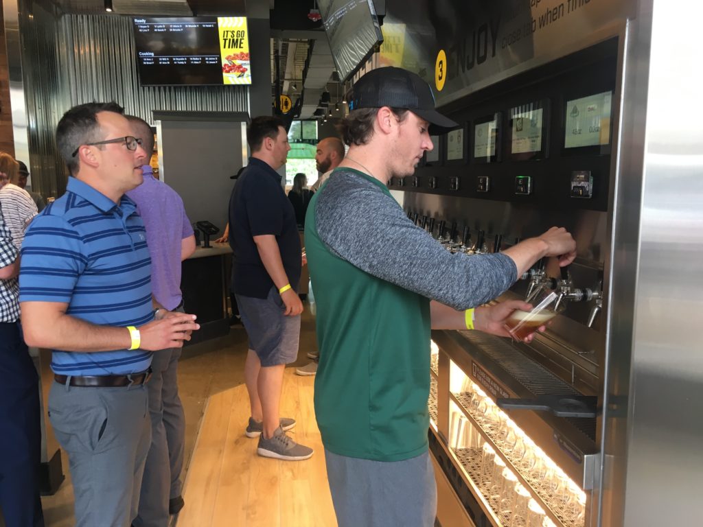 Customers pouring from PourMyBeer Wall at Buffalo Wild Wings Express