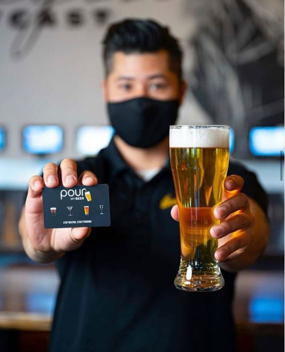 Saigon Outcast staff member and PourMyBeer beverage wall